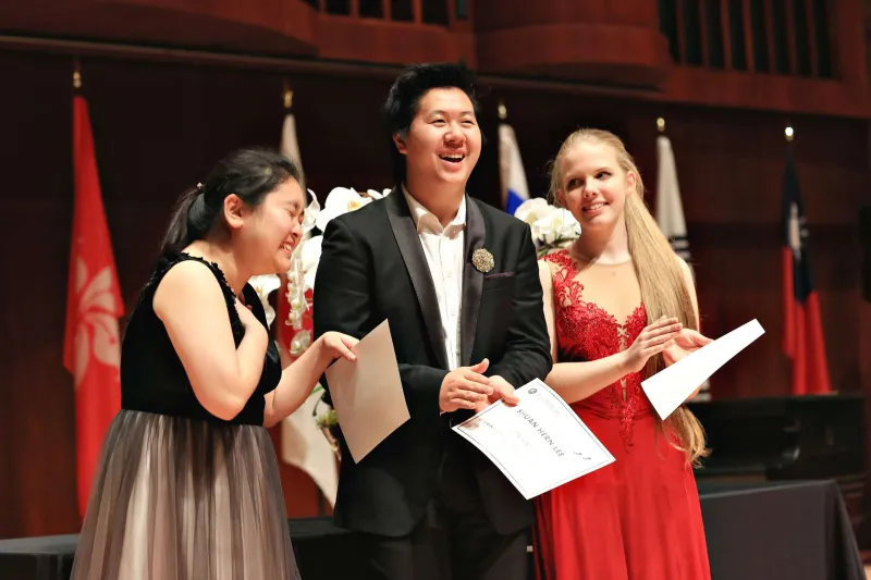 Three smiling and joyous semifinalists standing together