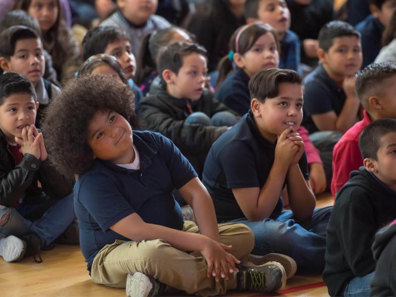 A host and pianist perform Cliburn in the classroom for a group of elementary students