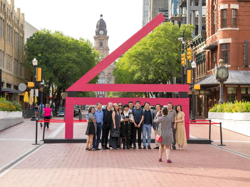 people pose in front of a large cliburn logo