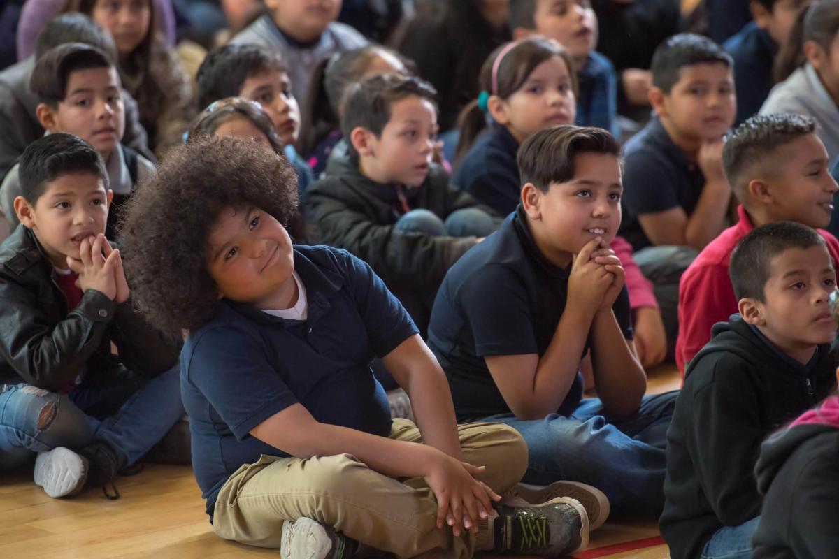 A host and pianist perform Cliburn in the classroom for a group of elementary students