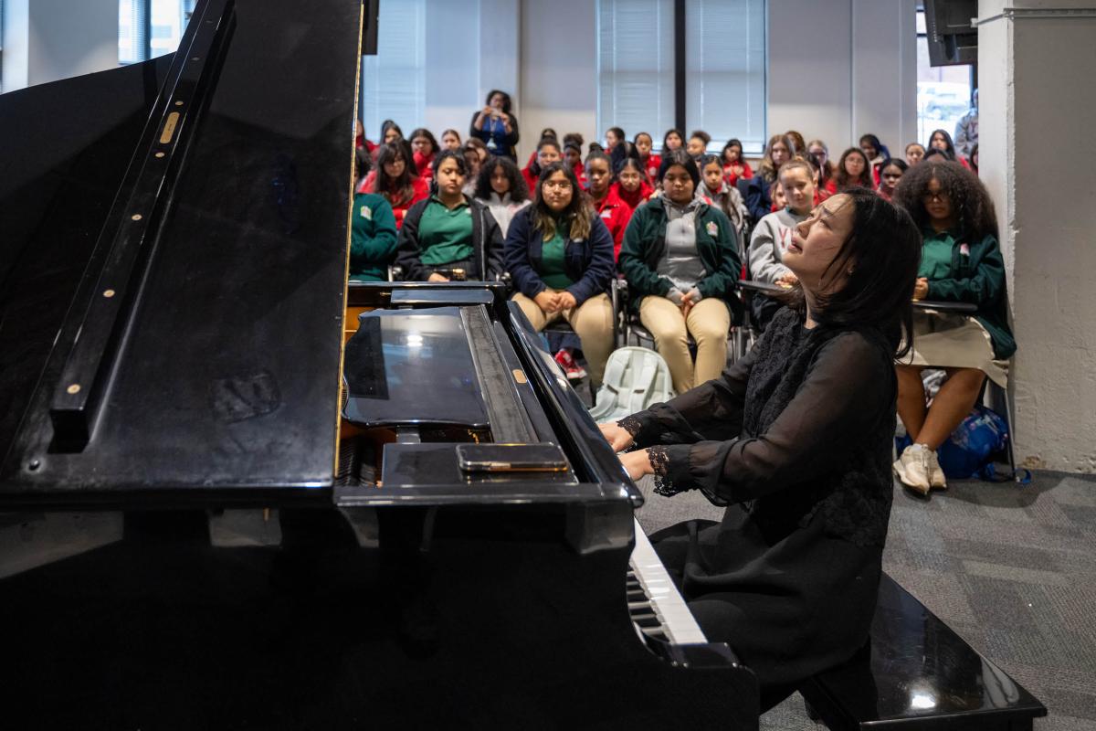 Cliburn artist Fei-Fei performs for a group of students at Fort Worth's Young Women's Leadership Academy.