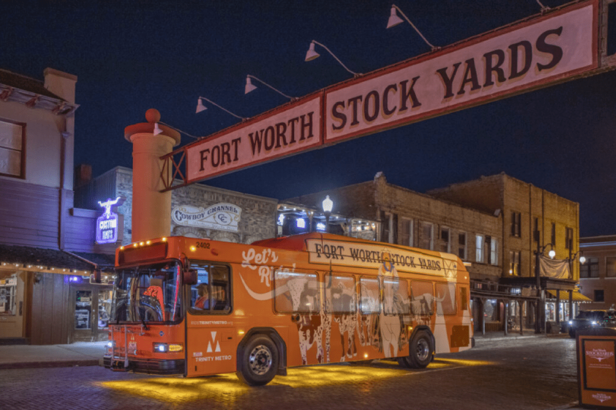An orange line bus in the fort worth stockyards
