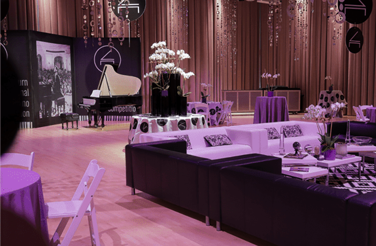 Tables and a piano at a formal event