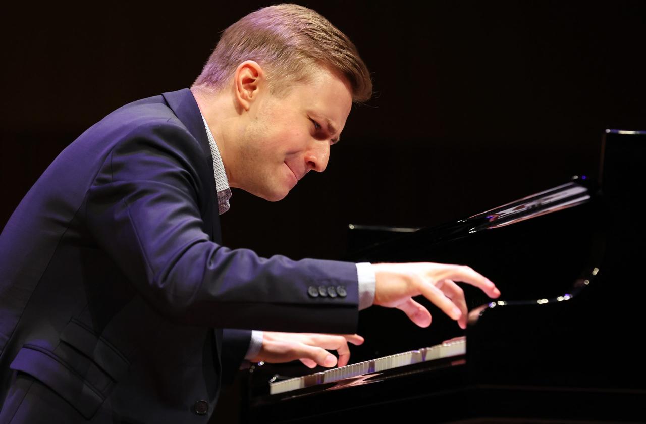 Close up of Dmytro Choni intensely playing piano